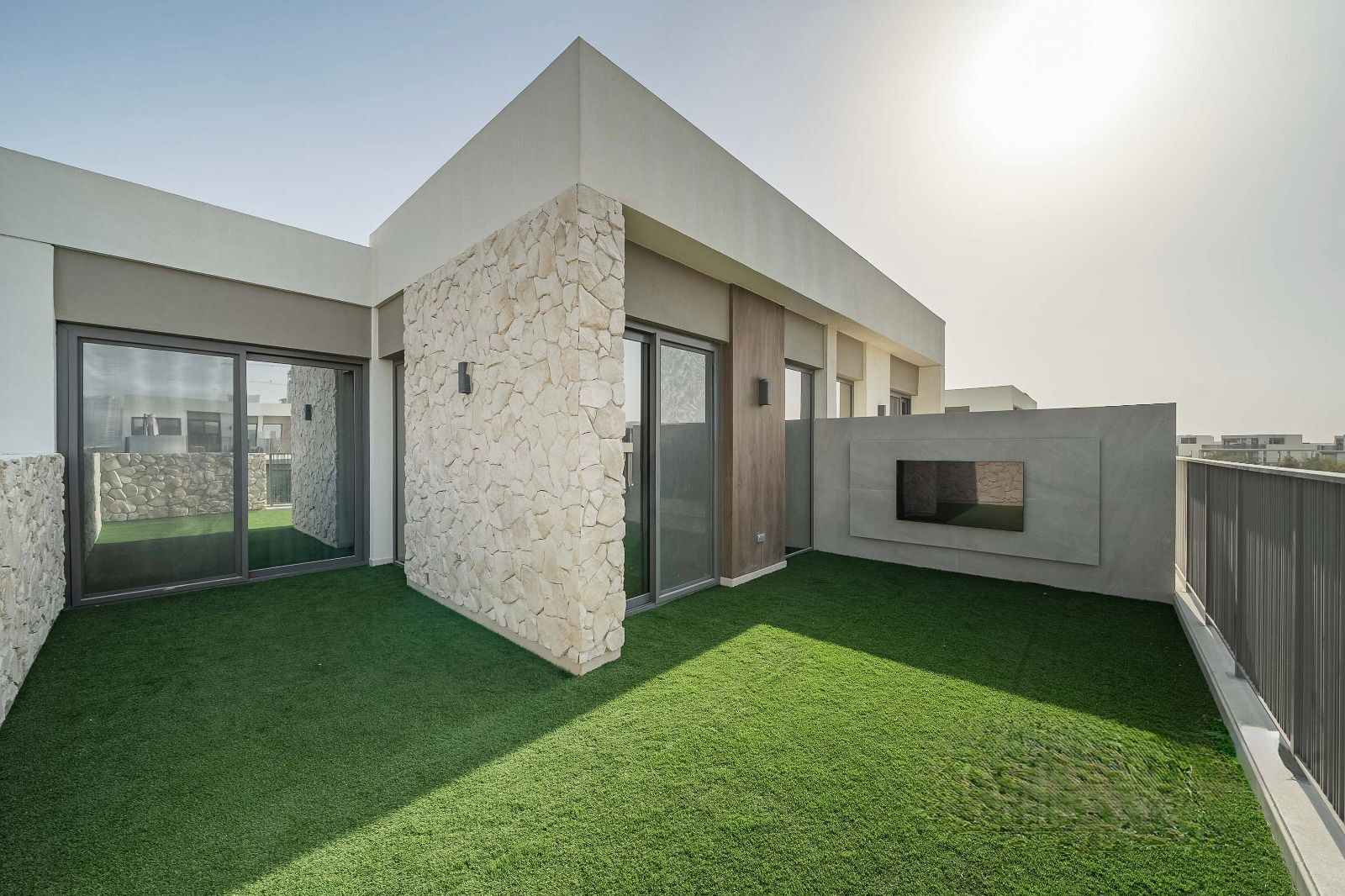 Upstairs roof terrace with stone-clad wall