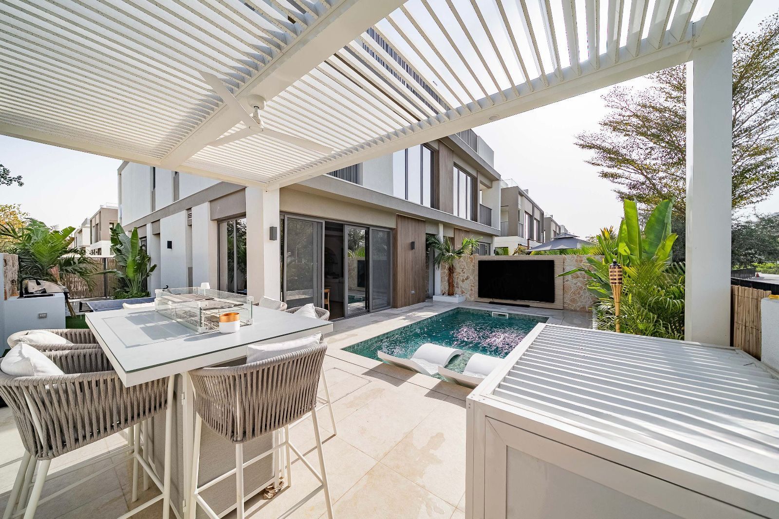 Under-pergola dining area with outdoor TV