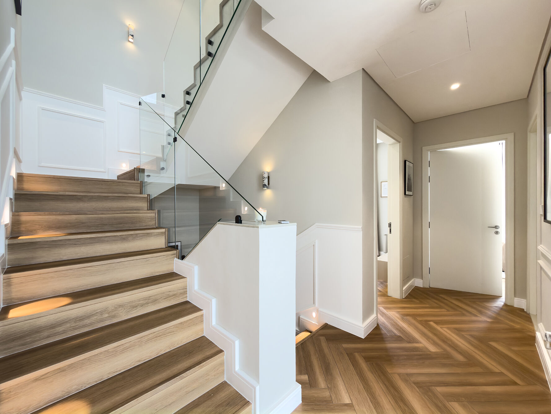 Staircase with glass banister and chevron oak