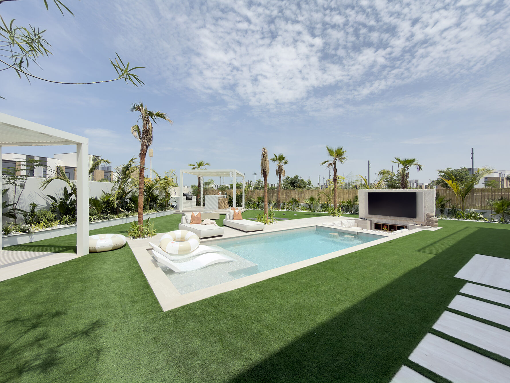 Pool, loungers, outdoor TV wall