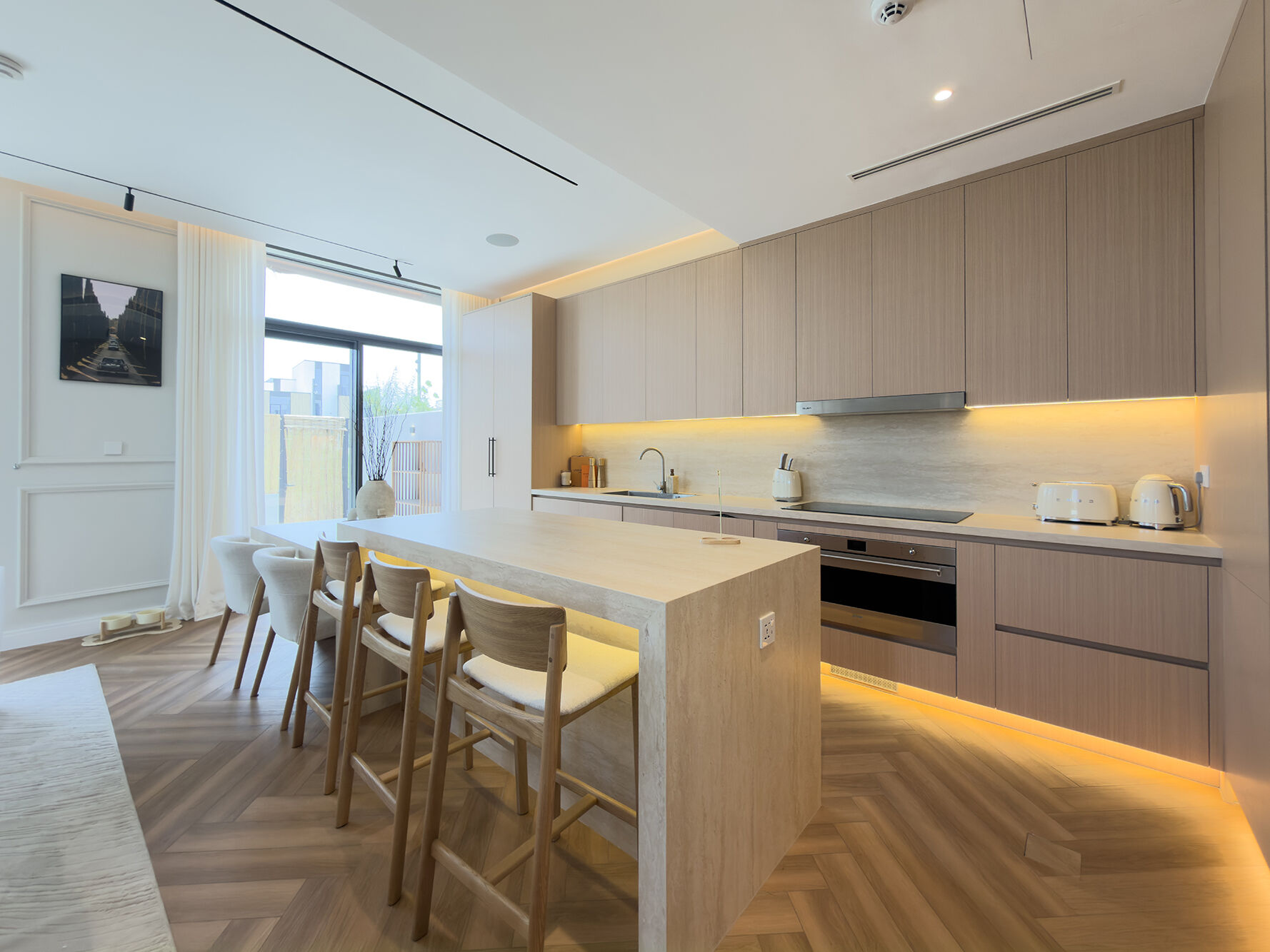 Kitchen with travertine island and oak cabinetry