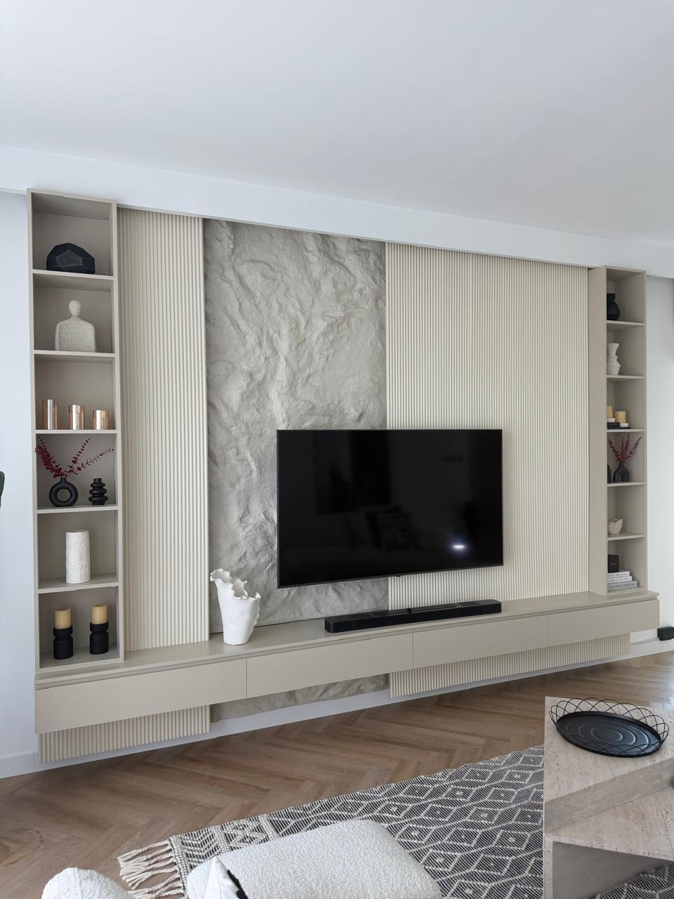 Bespoke media wall with fluted panelling and stone centrepiece